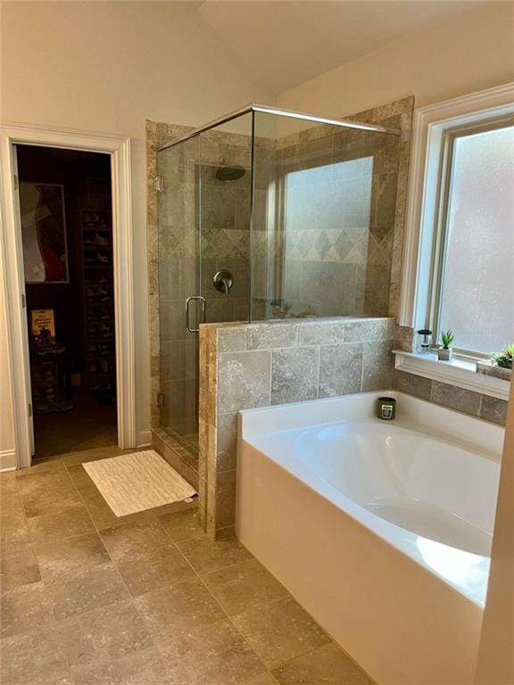 2208 Ginger Lake Dr NE, Conyers, GA 30013 - full bathroom with a bath, a stall shower, and a walk in closet