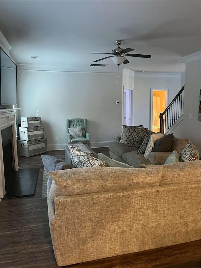 2208 Ginger Lake Dr NE, Conyers, GA 30013 - living area with ornamental molding, dark wood finished floors, stairs, ceiling fan, and a fireplace with raised hearth