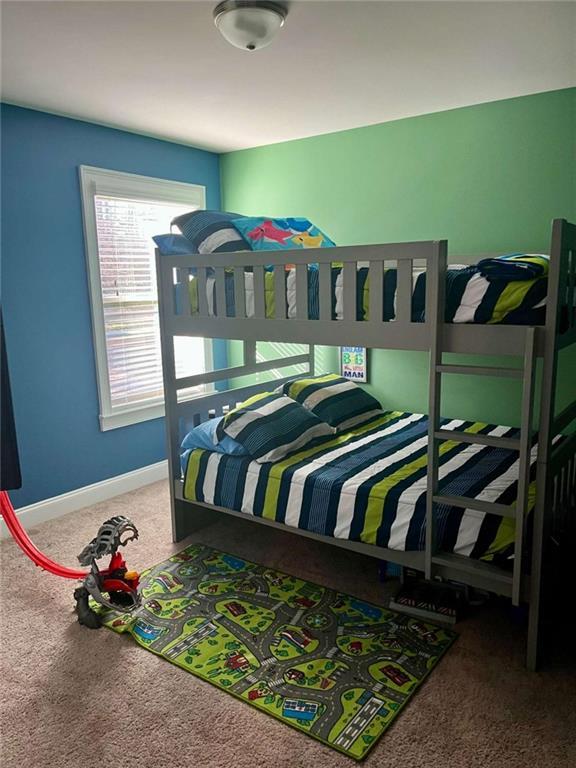 2208 Ginger Lake Dr NE, Conyers, GA 30013 - carpeted bedroom with baseboards