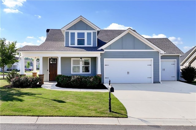 view of front facade with a front yard, a garage, and covered porch