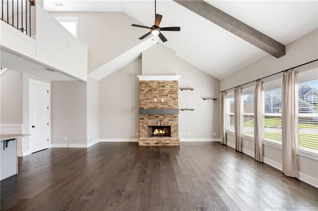 unfurnished living room with dark hardwood / wood-style flooring, high vaulted ceiling, a brick fireplace, and ceiling fan