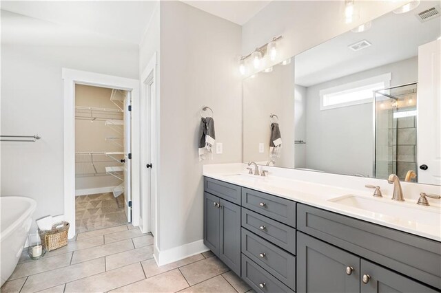 bathroom featuring tile patterned floors, vanity, and plus walk in shower