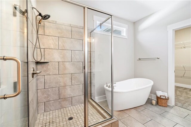 bathroom with shower with separate bathtub and tile patterned floors