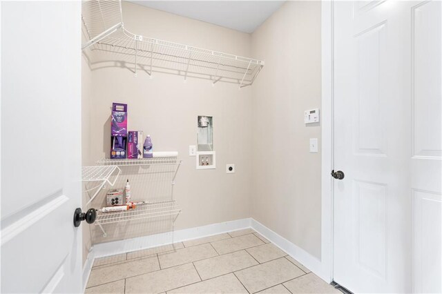 laundry area with electric dryer hookup, light tile patterned floors, and hookup for a washing machine