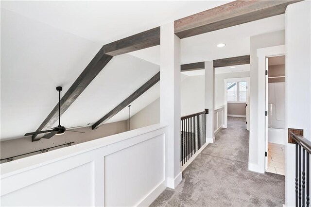 corridor featuring light carpet and lofted ceiling with beams