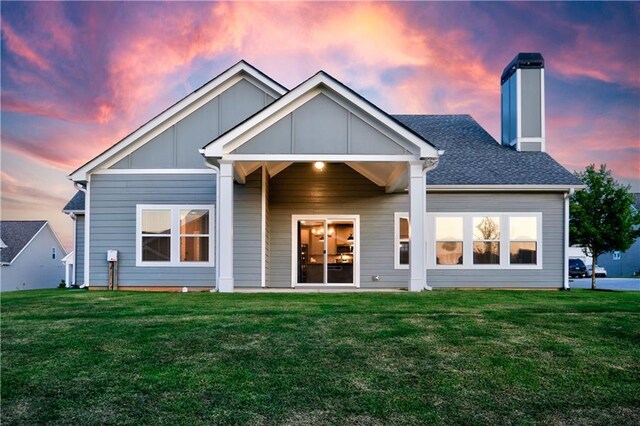 back house at dusk with a yard