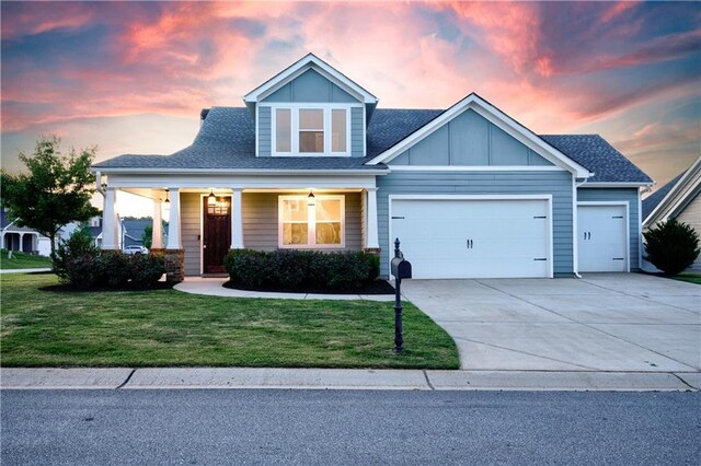 craftsman house featuring a yard and a garage