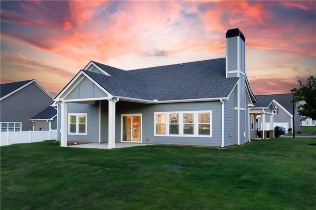 back house at dusk with a yard