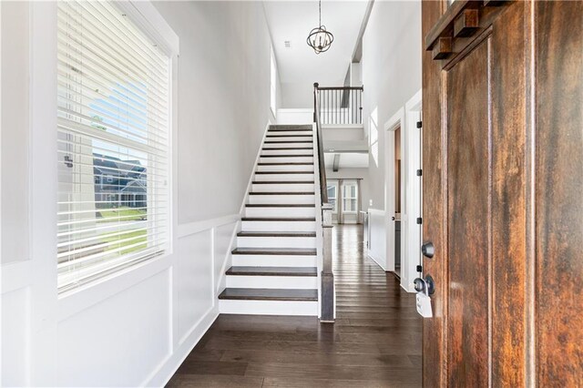 interior space featuring dark hardwood / wood-style flooring and a notable chandelier