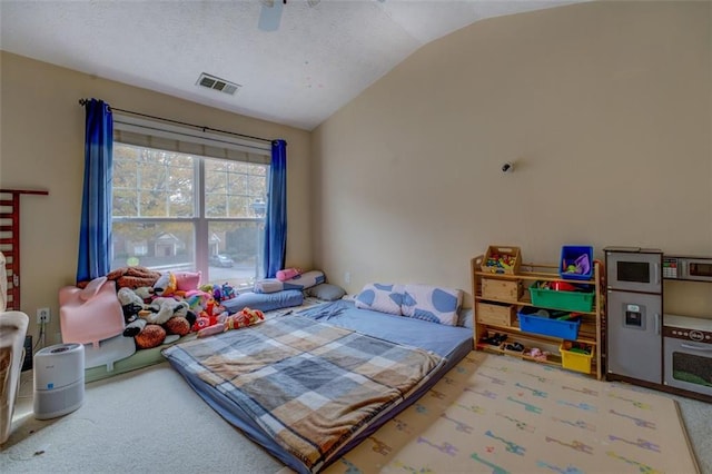 carpeted bedroom featuring vaulted ceiling and ceiling fan