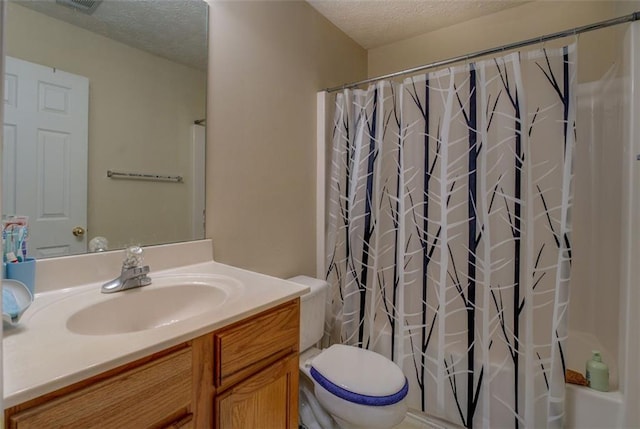 full bathroom featuring vanity, toilet, a textured ceiling, and shower / tub combo with curtain