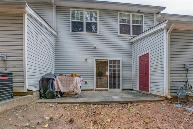 rear view of property featuring a patio and central AC