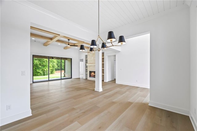 3601 Perry Smith Rd, Monroe, GA 30656 - interior space with a notable chandelier, beam ceiling, a fireplace, light wood-style flooring, and baseboards