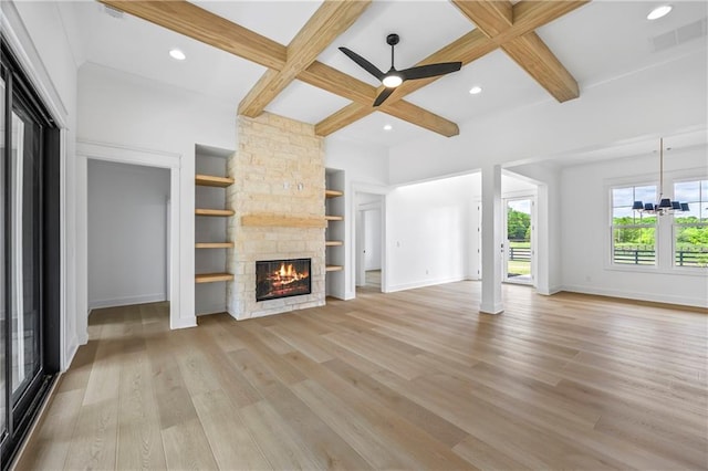 3601 Perry Smith Rd, Monroe, GA 30656 - unfurnished living room featuring a stone fireplace, baseboards, light wood-type flooring, coffered ceiling, and ceiling fan with notable chandelier