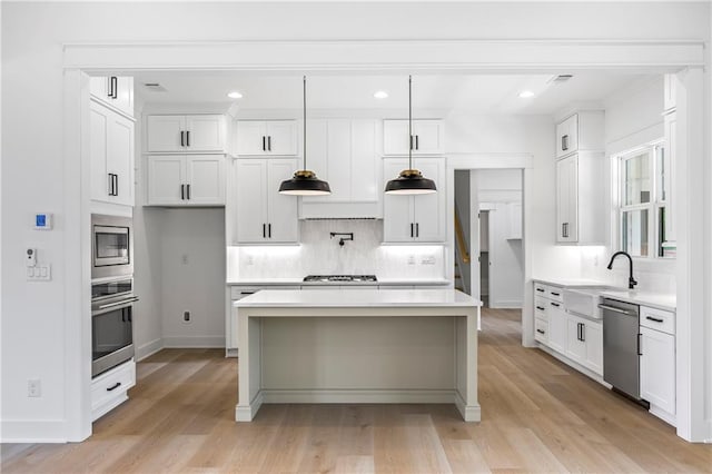 3601 Perry Smith Rd, Monroe, GA 30656 - kitchen featuring backsplash, stainless steel appliances, a kitchen island, and a sink