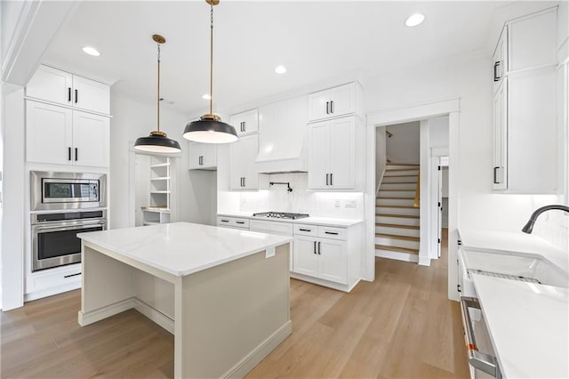 3601 Perry Smith Rd, Monroe, GA 30656 - kitchen with backsplash, a sink, appliances with stainless steel finishes, and light wood-style flooring