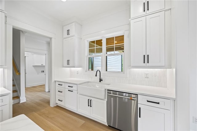 3601 Perry Smith Rd, Monroe, GA 30656 - kitchen with white cabinets, light wood-style floors, light countertops, backsplash, and stainless steel dishwasher