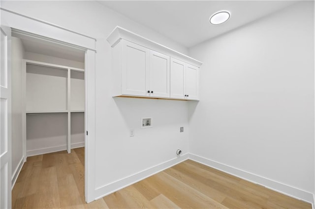 3601 Perry Smith Rd, Monroe, GA 30656 - clothes washing area featuring baseboards, light wood-type flooring, cabinet space, electric dryer hookup, and washer hookup