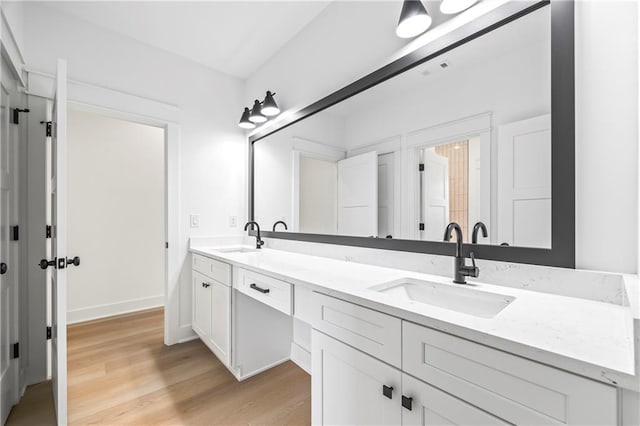 3601 Perry Smith Rd, Monroe, GA 30656 - bathroom with double vanity, a sink, and wood finished floors