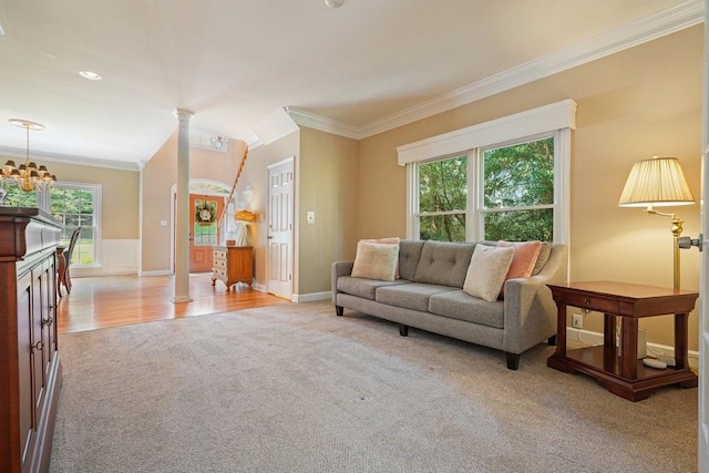 921 Laurel Crest Dr, Woodstock, GA 30189 - living area with light colored carpet, ornamental molding, a chandelier, and a wainscoted wall