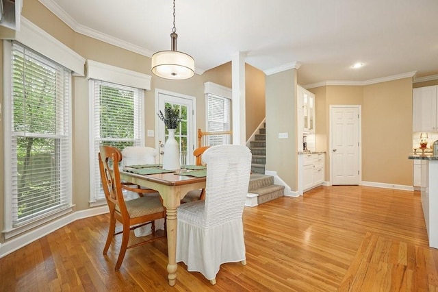 921 Laurel Crest Dr, Woodstock, GA 30189 - dining area featuring stairway, light wood finished floors, crown molding, baseboards, and recessed lighting