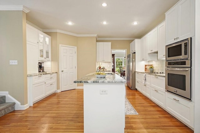 921 Laurel Crest Dr, Woodstock, GA 30189 - kitchen with stainless steel appliances, ornamental molding, backsplash, recessed lighting, and light wood-type flooring