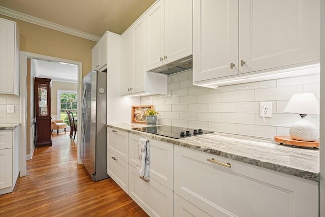 921 Laurel Crest Dr, Woodstock, GA 30189 - kitchen featuring freestanding refrigerator, ornamental molding, black electric cooktop, white cabinets, and light wood-style floors