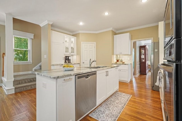 921 Laurel Crest Dr, Woodstock, GA 30189 - kitchen with appliances with stainless steel finishes, light wood finished floors, white cabinetry, crown molding, and recessed lighting