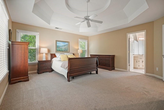 921 Laurel Crest Dr, Woodstock, GA 30189 - carpeted bedroom with a tray ceiling, multiple windows, and baseboards