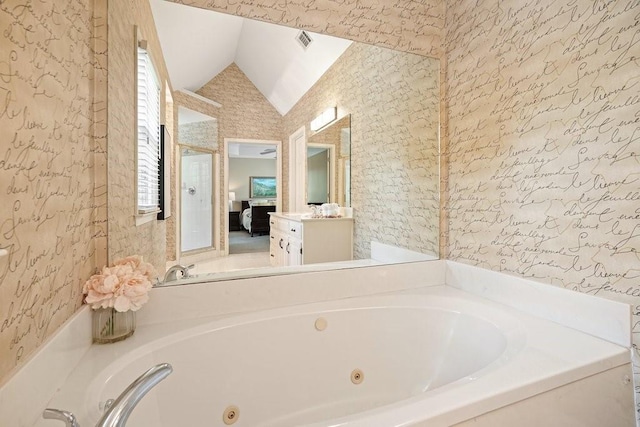 921 Laurel Crest Dr, Woodstock, GA 30189 - full bath with a tub with jets, vaulted ceiling, vanity, connected bathroom, and wallpapered walls