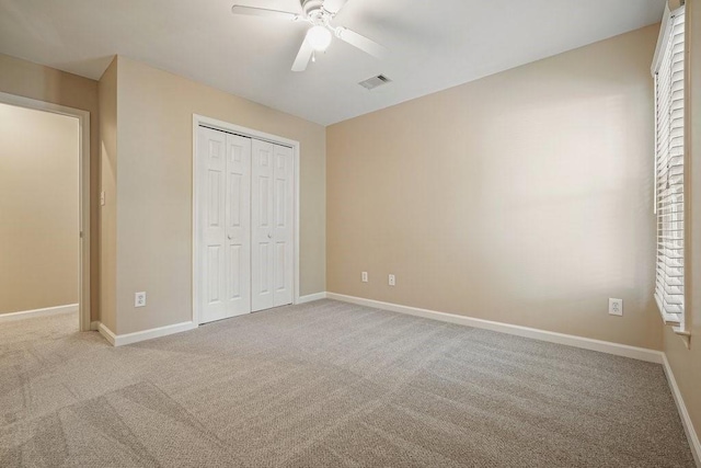 921 Laurel Crest Dr, Woodstock, GA 30189 - unfurnished bedroom featuring carpet, a closet, baseboards, and a ceiling fan