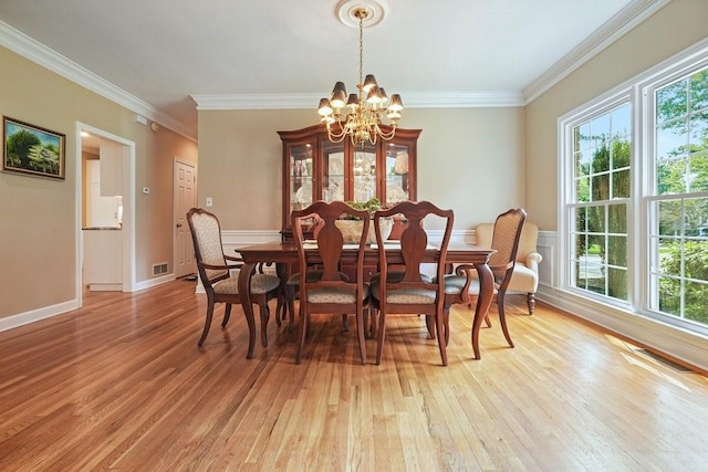 921 Laurel Crest Dr, Woodstock, GA 30189 - dining room with light wood finished floors, a chandelier, plenty of natural light, and crown molding