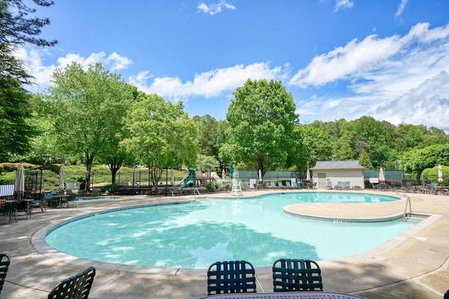 921 Laurel Crest Dr, Woodstock, GA 30189 - community pool with a patio area and view of scattered trees