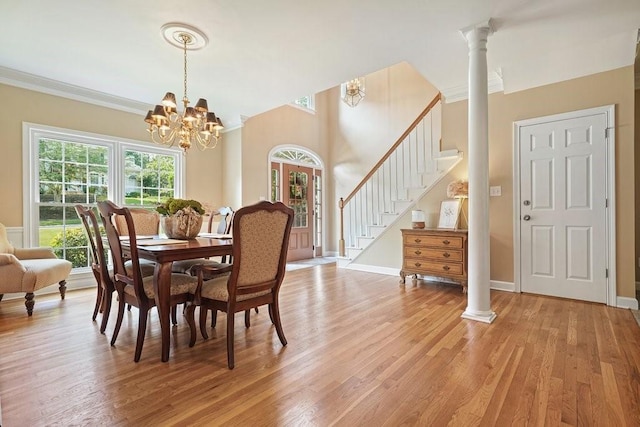 921 Laurel Crest Dr, Woodstock, GA 30189 - dining space with stairs, light wood-style flooring, ornamental molding, a chandelier, and baseboards