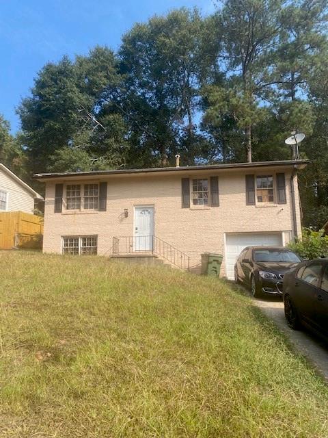 view of front of property with a garage and a front lawn