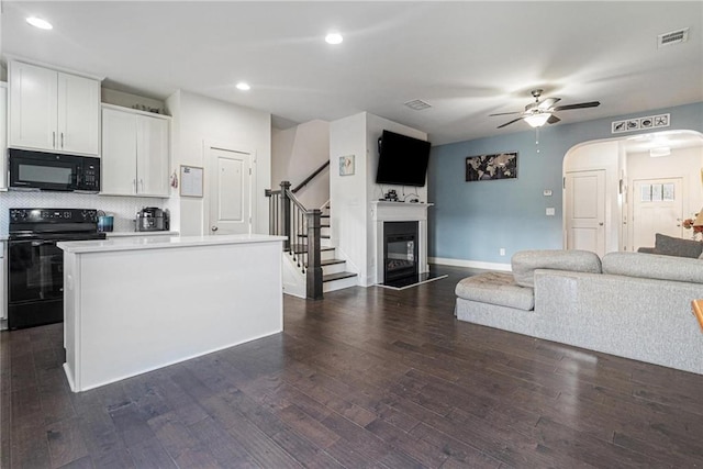 160 Auburn Gate Ln, Auburn, GA 30011 - kitchen with black appliances, ceiling fan, open floor plan, backsplash, and light countertops