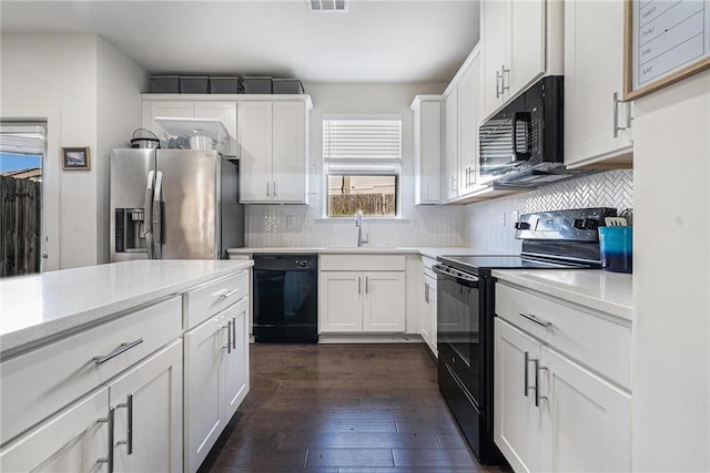 160 Auburn Gate Ln, Auburn, GA 30011 - kitchen featuring black appliances, dark wood-style floors, decorative backsplash, and white cabinetry