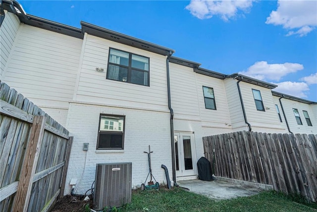 160 Auburn Gate Ln, Auburn, GA 30011 - rear view of property with brick siding, a fenced backyard, and a patio