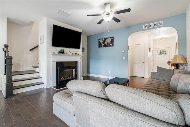 160 Auburn Gate Ln, Auburn, GA 30011 - living room with arched walkways, ceiling fan, dark wood finished floors, stairway, and a glass covered fireplace