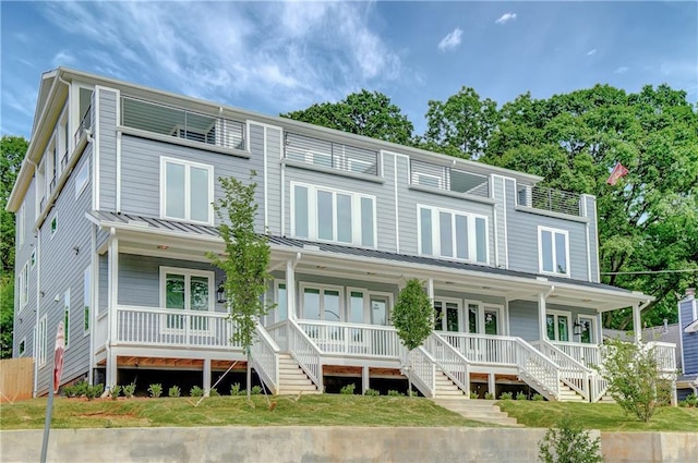 454 Connally St SE, Atlanta, GA 30312 - townhome / multi-family property featuring covered porch, a standing seam roof, a metal roof, and stairway