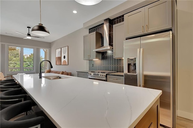 454 Connally St SE, Atlanta, GA 30312 - kitchen with appliances with stainless steel finishes, wall chimney range hood, ceiling fan, recessed lighting, and light stone counters