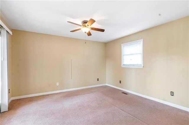 unfurnished room featuring light carpet and ceiling fan