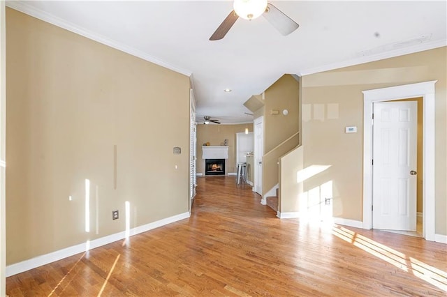 unfurnished room featuring hardwood / wood-style flooring, crown molding, and ceiling fan