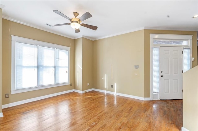 interior space featuring ceiling fan, crown molding, and wood-type flooring