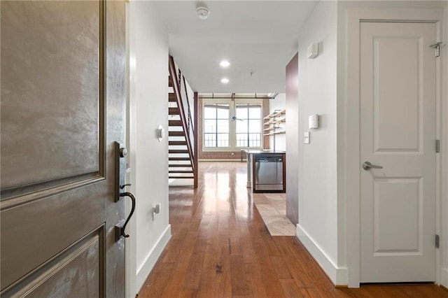 corridor with light hardwood / wood-style flooring