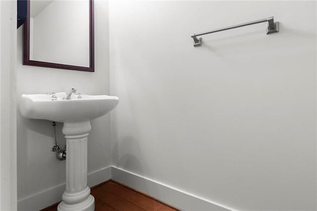 bathroom featuring ornate columns and wood-type flooring