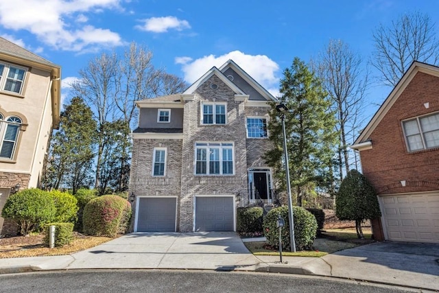 view of front of property with an attached garage, concrete driveway, and brick siding