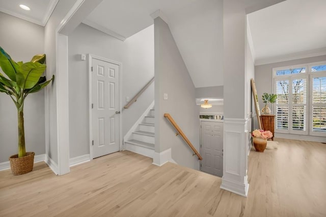 entrance foyer with recessed lighting, wood finished floors, baseboards, stairs, and ornamental molding