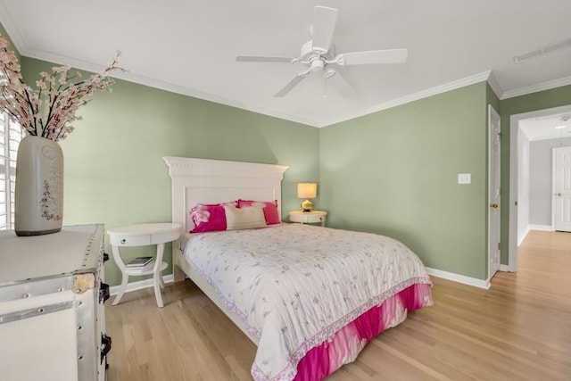 bedroom featuring light wood finished floors, attic access, visible vents, baseboards, and crown molding