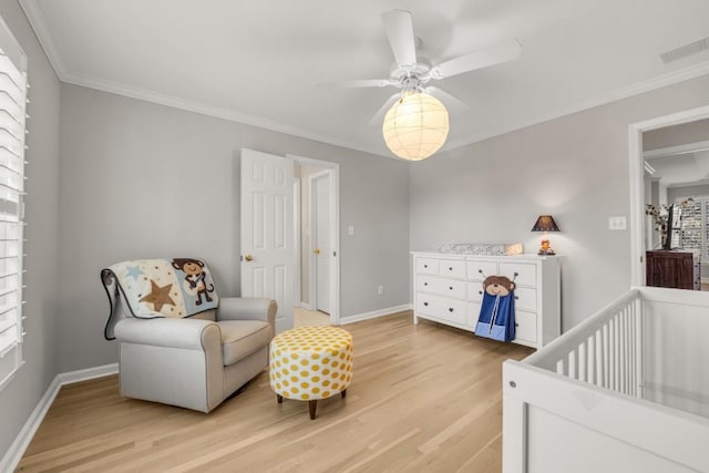 bedroom with baseboards, light wood-style flooring, visible vents, and crown molding